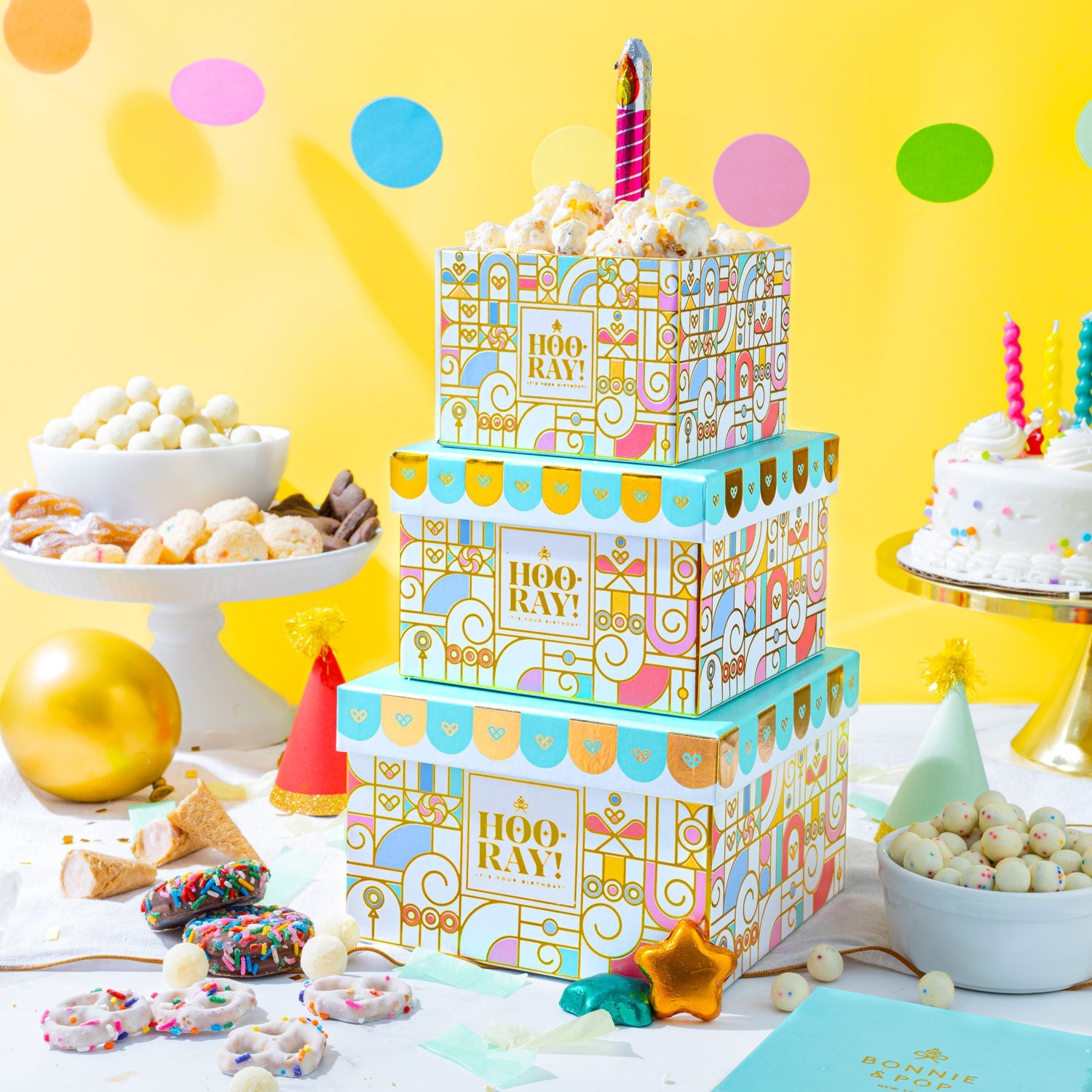 Make every birthday unforgettable. This three-tier birthday gift tower is packed with chocolates, cookies, nuts, and festive treats—beautifully wrapped and ready to wow.