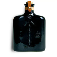 Classic ceramic flask inspired by the historic culture of distilling spirits, featuring intricate embossing, leather fastening, and brass hardware. Perfect for casual picnics, bar tops, or mantles.