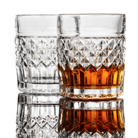 Set of 2 crystal whiskey glasses, showcasing one empty and one filled with whiskey, perfect for cocktails.