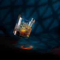 Elegant Reserve Crystal whiskey glass showcasing whiskey, perfect for chilling stones and sophisticated barware.