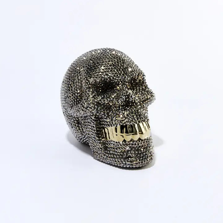 Rhinestone skull piggy bank adorned with sparkling rhinestones, striking decor and functional accessory. Perfect for storing coins and small bills. 