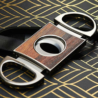 Elegant cigar cutter featuring wooden design and stainless steel accents, perfect accessory for cigar aficionados.