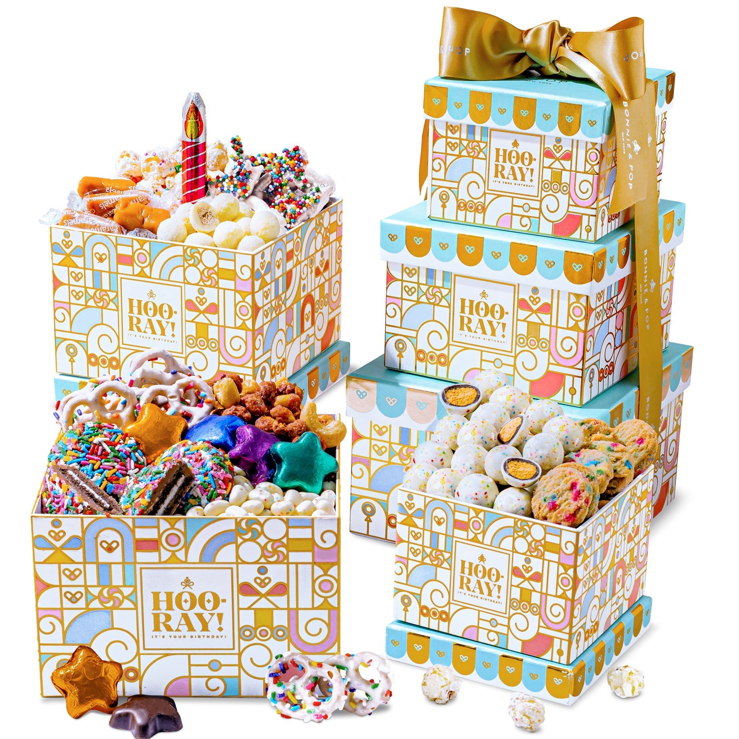 A three-tiered gift tower with an assortment of chocolate covered and other sweet snacks, wrapped in birthday-themed packaging with decorative gold ribbon.