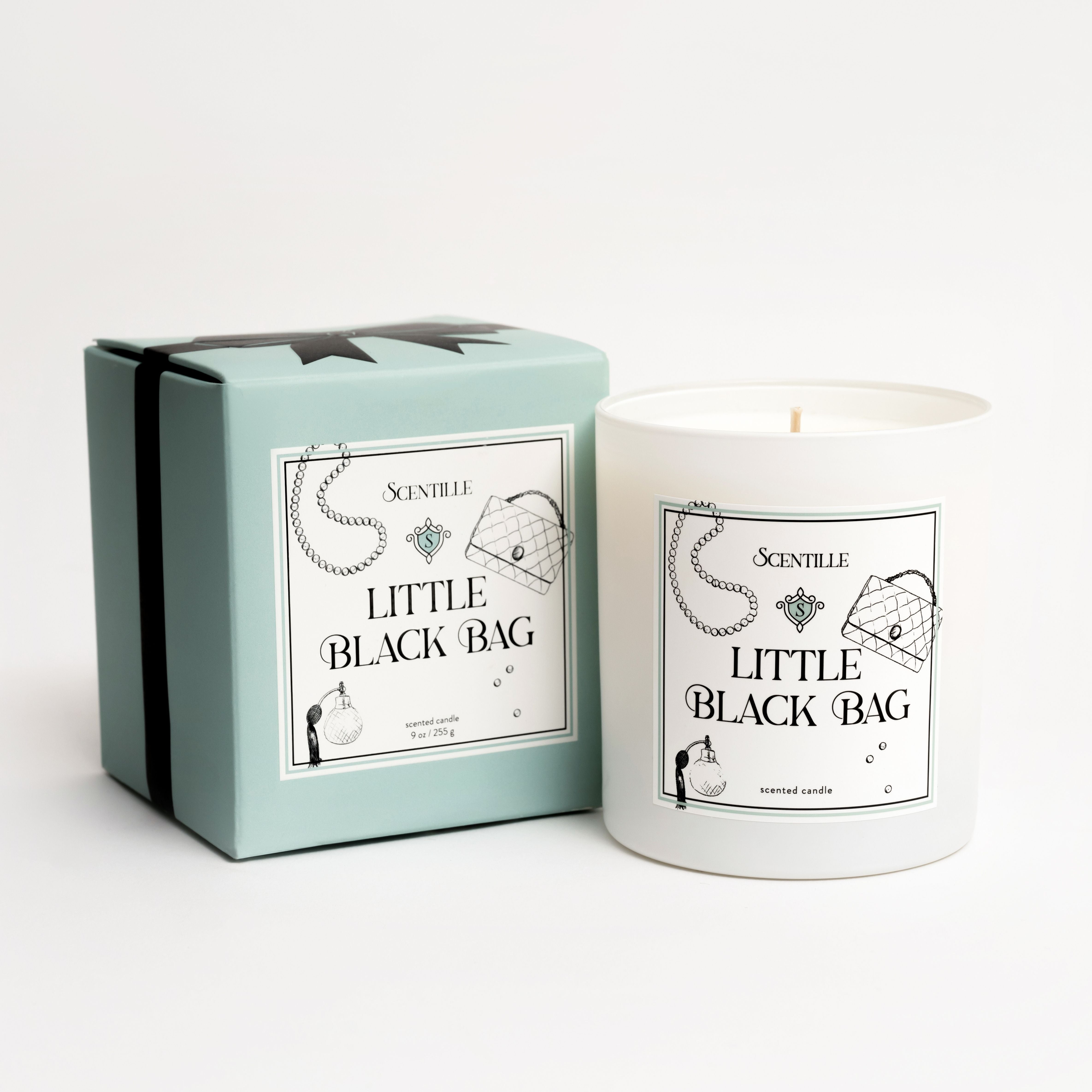 Candle labeled 'Little Black Bag' with packaging on a white background