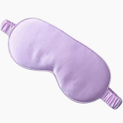 Purple satin eye mask on a white background